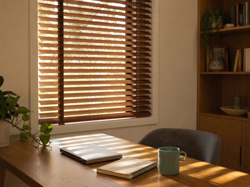 Study window with timber venetian blinds tilted against glare